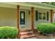 Covered front porch with decorative columns and brick steps leading to a stylish front door at 267 Winthrow Creek Rd, Mooresville, NC 28115