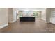 Modern kitchen boasts a spacious island, white cabinets, and a view into the breakfast nook at 267 Winthrow Creek Rd, Mooresville, NC 28115