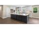 Modern kitchen features a large island, white cabinetry, and stainless steel appliances at 267 Winthrow Creek Rd, Mooresville, NC 28115