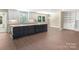Open kitchen with a large dark island, white cabinets, and views of the breakfast nook at 267 Winthrow Creek Rd, Mooresville, NC 28115