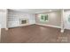 Bright living room featuring a cozy fireplace, built-in bookshelves, and hardwood floors at 267 Winthrow Creek Rd, Mooresville, NC 28115