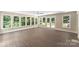Bright sunroom features many large windows and a glass door for ample sunlight at 267 Winthrow Creek Rd, Mooresville, NC 28115