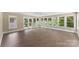 Bright sunroom features large windows, glass doors, and wood floors at 267 Winthrow Creek Rd, Mooresville, NC 28115