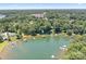 Aerial view showcasing the lakefront property with private docks surrounded by lush tree coverage at 2704 Apache Trl, Denver, NC 28037
