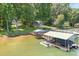Aerial view of a lakefront property with multiple boat docks and lush green surroundings at 2704 Apache Trl, Denver, NC 28037