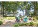 Stone patio with outdoor seating and fire pit overlooking the lake and private boat dock at 2704 Apache Trl, Denver, NC 28037