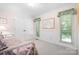 Serene bedroom with classic décor, featuring large windows and closet doors for ample natural light and storage at 2704 Apache Trl, Denver, NC 28037