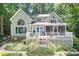 Charming home with large windows and a spacious deck overlooking a lake, nestled among mature trees at 2704 Apache Trl, Denver, NC 28037