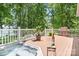 Outdoor deck featuring a hot tub, grill, and scenic lake view, ideal for relaxation and entertaining at 2704 Apache Trl, Denver, NC 28037