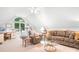 Spacious living room under a vaulted ceiling, featuring a large window and comfortable seating, ideal for relaxation at 2704 Apache Trl, Denver, NC 28037