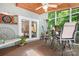 Inviting screened porch with rustic wooden accents, complete with a dining set and comfortable seating area at 2704 Apache Trl, Denver, NC 28037