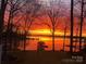 Stunning waterfront view at sunset with vibrant colors reflecting on the tranquil lake at 2704 Apache Trl, Denver, NC 28037