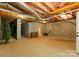 Unfinished basement with exposed pipes, cinderblock walls, and concrete floors at 2818 Levinfield Ct, Lincolnton, NC 28092