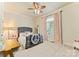 Cozy bedroom with a ceiling fan, gray cushioned bed, and a window allowing natural light at 2818 Levinfield Ct, Lincolnton, NC 28092