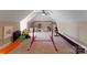 Bright bonus room showcasing fun play area with slide, gymnastic bars, and furniture at 2818 Levinfield Ct, Lincolnton, NC 28092