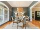 Dining room featuring a glass table, elegant chandelier, and wall art at 2818 Levinfield Ct, Lincolnton, NC 28092