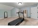 Bright exercise room featuring a treadmill, weights, neutral carpet, and pale blue walls at 2818 Levinfield Ct, Lincolnton, NC 28092