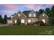 Brick house with a manicured lawn, dormer windows, and inviting front porch at 2818 Levinfield Ct, Lincolnton, NC 28092