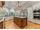 Gourmet kitchen with granite counters, custom cabinets, hardwood floors, and a large center island at 2818 Levinfield Ct, Lincolnton, NC 28092