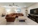 Casual living area featuring a leather sectional, wall decorations, and a modern entertainment center at 2818 Levinfield Ct, Lincolnton, NC 28092