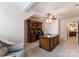 Home office featuring wooden desk, built-in bookcase, neutral walls, and ceiling fan at 2818 Levinfield Ct, Lincolnton, NC 28092