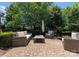 Brick patio features outdoor seating and is surrounded by mature landscaping and trees at 2818 Levinfield Ct, Lincolnton, NC 28092