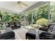 Enclosed porch features a ceiling fan, comfortable seating, and beautiful outdoor views at 2818 Levinfield Ct, Lincolnton, NC 28092