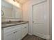 Bathroom boasts double sinks with granite countertops, white cabinets, and modern fixtures at 285 Hannah Ave, Salisbury, NC 28147