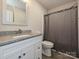 Bathroom features a single sink with granite countertops and a shower with gray curtain at 285 Hannah Ave, Salisbury, NC 28147