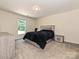 Bedroom features a modern bed with gray frame and a black blanket, plus a large window at 285 Hannah Ave, Salisbury, NC 28147