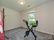 Bedroom features a large window, an exercise bike, and neutral carpet at 285 Hannah Ave, Salisbury, NC 28147