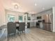 Modern kitchen featuring gray cabinets, stainless steel appliances, and an adjacent dining area at 285 Hannah Ave, Salisbury, NC 28147