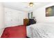 Bedroom with red carpet, white walls, ceiling fan, and 2 entry doors at 2916 Northwood Dr, Monroe, NC 28110