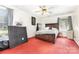 Spacious bedroom with red carpet, ceiling fan, and a large window at 2916 Northwood Dr, Monroe, NC 28110