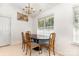 Cozy dining area featuring a modern chandelier and a large window at 2916 Northwood Dr, Monroe, NC 28110