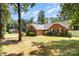 Beautiful brick home with mature trees and a well-kept lawn at 2916 Northwood Dr, Monroe, NC 28110