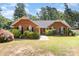 Charming brick home with a well-manicured lawn and lush landscaping at 2916 Northwood Dr, Monroe, NC 28110