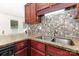 Kitchen sink with granite countertops, mosaic backsplash, and stainless steel faucet at 2916 Northwood Dr, Monroe, NC 28110