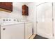 Bright laundry room with washer, dryer, storage cabinets, and access door at 2916 Northwood Dr, Monroe, NC 28110