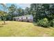 Expansive backyard with mature trees and lush green lawn, perfect for outdoor activities and relaxation at 326 Gorrell St, Shelby, NC 28152
