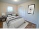 Staged bedroom with hardwood floors, closet with white doors and a comfy bed at 326 Gorrell St, Shelby, NC 28152