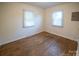 Spacious bedroom with hardwood floors and two windows for ample natural light at 326 Gorrell St, Shelby, NC 28152
