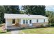 Inviting home with charming architectural details, a covered carport, and a well-maintained yard at 326 Gorrell St, Shelby, NC 28152