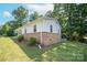 Charming home with brick accents, mature trees, and lush green lawn in a desirable neighborhood at 326 Gorrell St, Shelby, NC 28152
