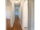 Hallway featuring hardwood flooring, neutral paint, and access to various rooms within the home at 326 Gorrell St, Shelby, NC 28152
