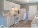 Modern kitchen boasts white cabinetry, stylish backsplash, and stainless appliances with a convenient layout at 326 Gorrell St, Shelby, NC 28152