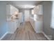 Modern kitchen boasts white cabinetry, stylish backsplash, and stainless appliances with a convenient layout at 326 Gorrell St, Shelby, NC 28152