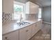 Bright kitchen features white cabinets, marbled countertops, and a stylish herringbone backsplash at 326 Gorrell St, Shelby, NC 28152