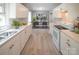 Bright kitchen features white cabinets, appliances and marble countertops, connected to dining area at 326 Gorrell St, Shelby, NC 28152