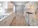 Well-lit kitchen showcasing white cabinets, new backsplash, modern appliances, and durable flooring at 326 Gorrell St, Shelby, NC 28152